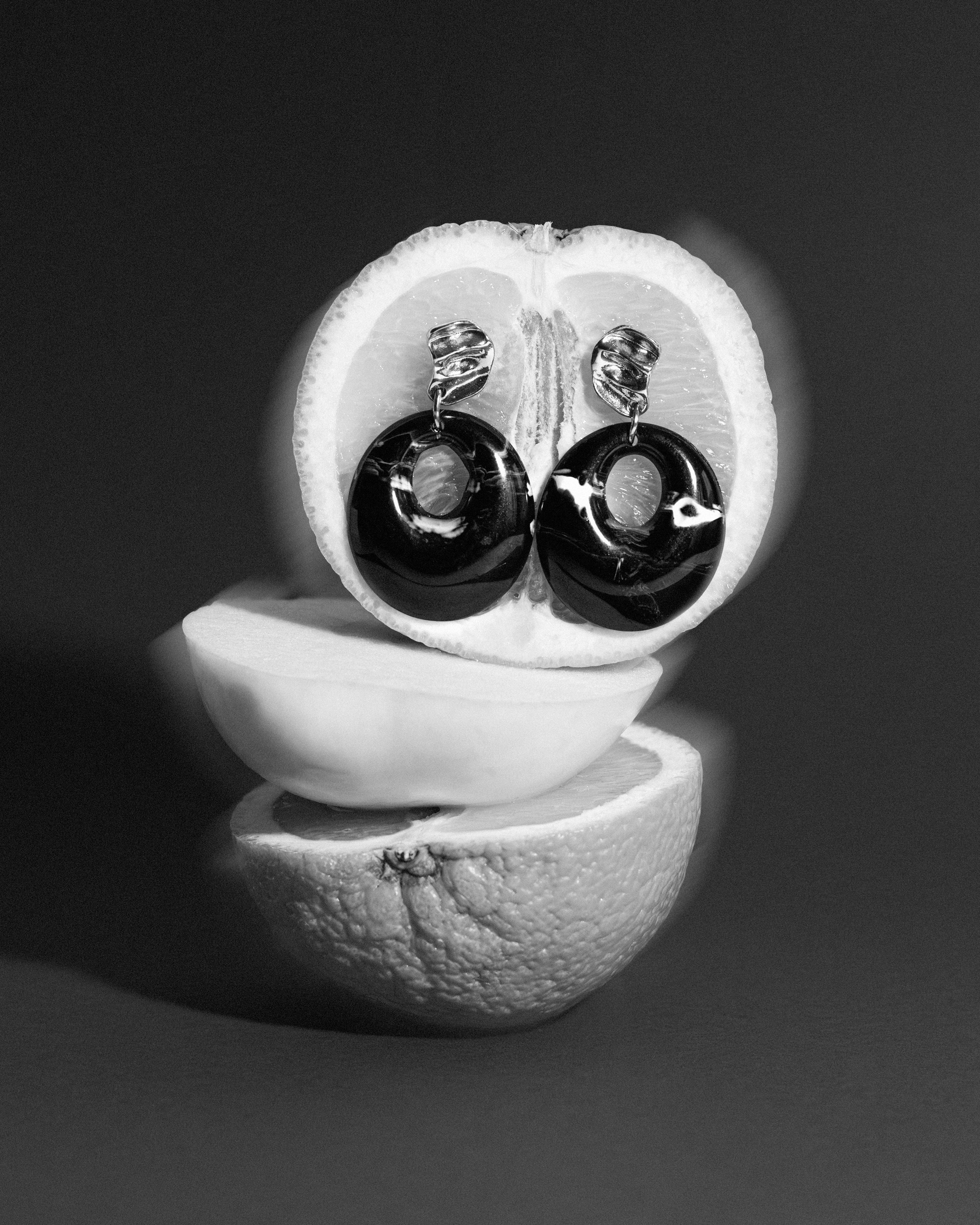 black and white earrings on fruit
